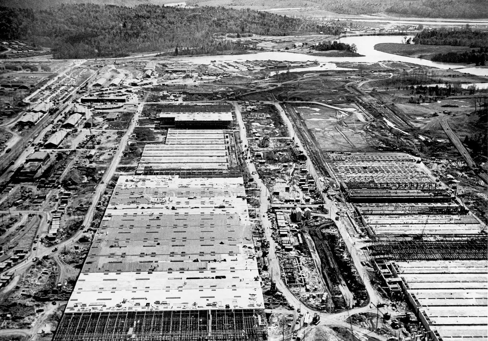 K-25 rising at Oak Ridge in April 1944; finished, it put 44 acres under one roof and was the largest building in the world.