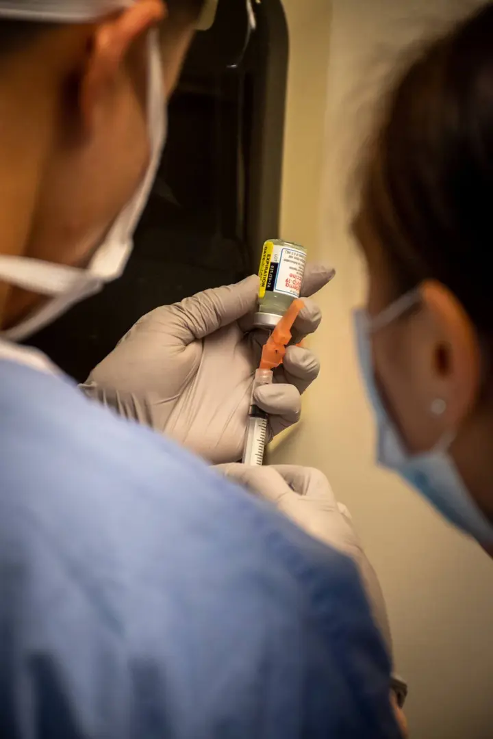 Navy hospital corpsmen at Naval Hospital Bremerton, Washington, draw one of the first Moderna doses, 23 December 2020.